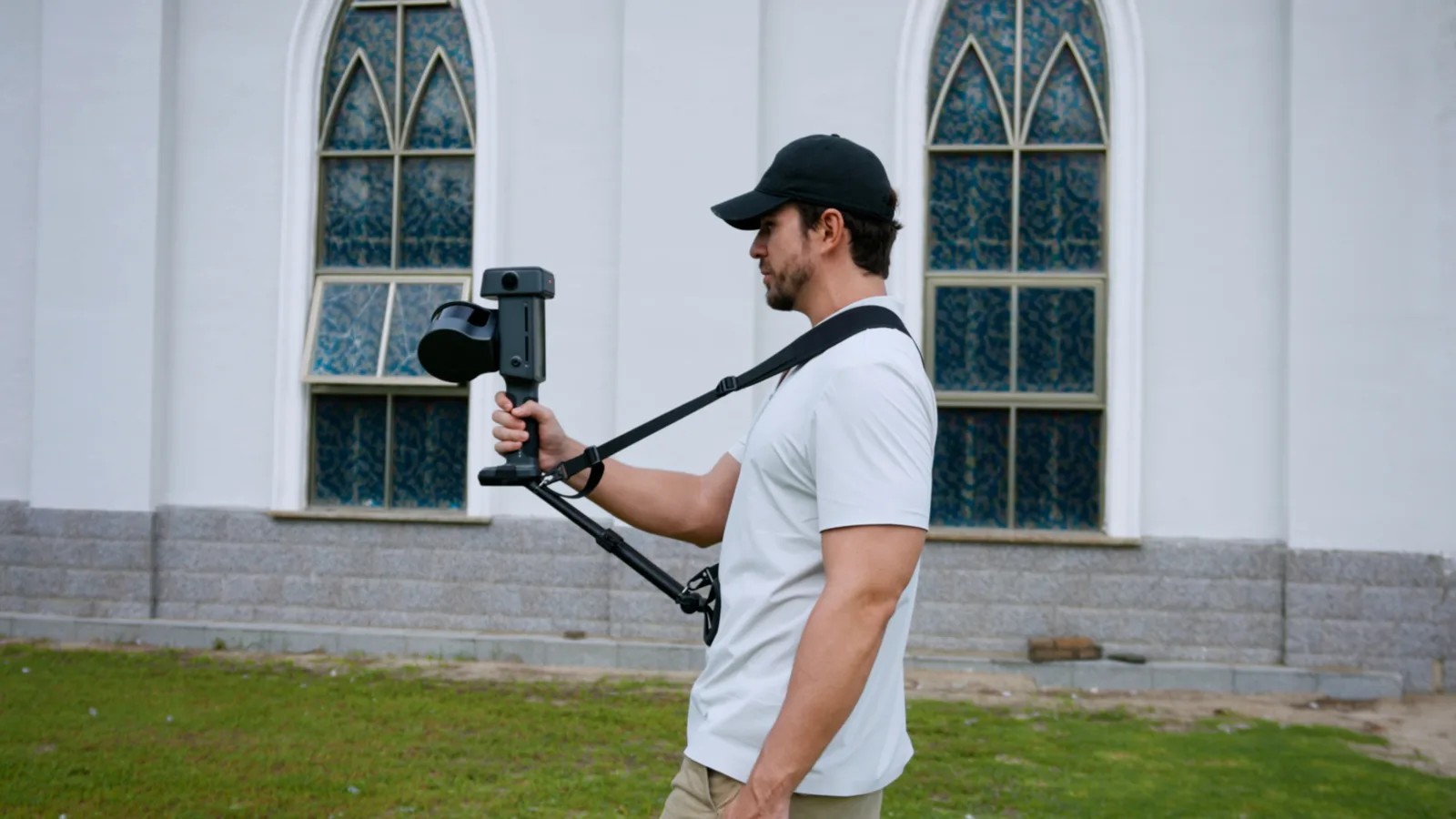 XGRIDS Lixel L3 handheld SLAM scanner in use on a shoulder strap during an exterior capture