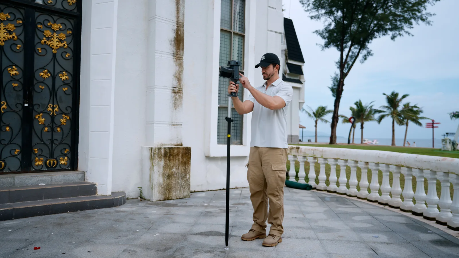 Lixel L3 mounted on a survey pole to record a ground control point beside a building