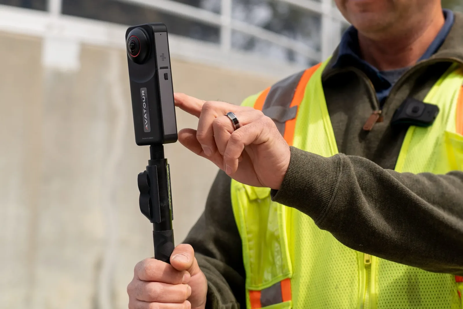 Site engineer holding a 360 camera on a handle for a virtual inspection capture